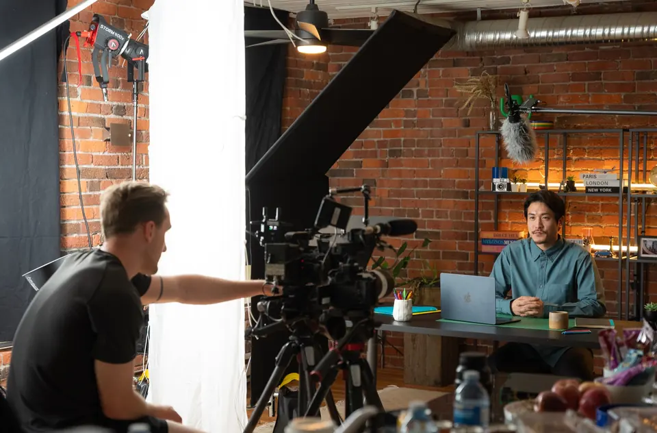 Camera operator framing a desk shot